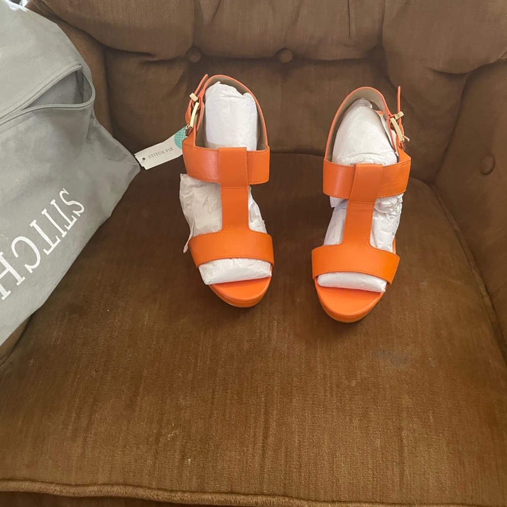 NIB orange heeled sandals. Never worn. With original dusk bag.